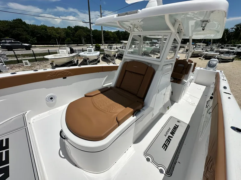 Slide: The Image of 2023 Twin Vee 340 GFX CC boat with brown seating and white deck. - 8