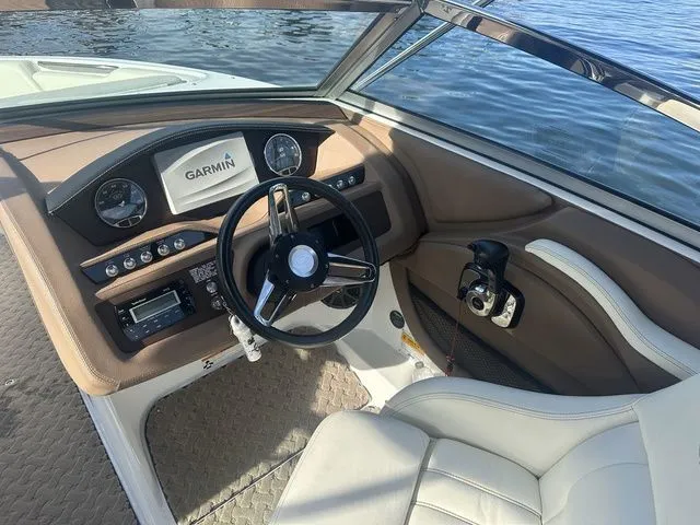 Slide: The Image of 2014 Cobalt R3 boat dashboard with Garmin navigation, steering wheel, and controls. - 4