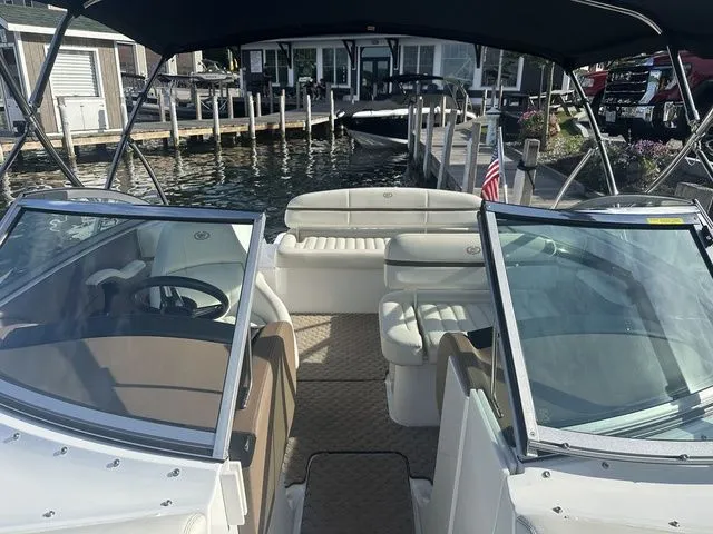 Slide: The Image of 2014 Cobalt R3 boat interior with seating, docked by waterfront homes. - 5