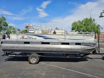 Slide: The Image of 2008 Sun Tracker FISHING BARGE 21 pontoon boat on trailer, parked outdoors. - 3