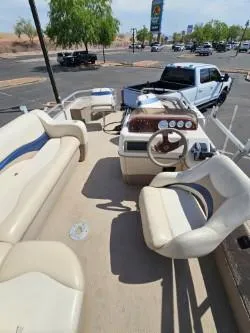 Slide: The Image of 2008 Sun Tracker FISHING BARGE 21 pontoon boat interior with seating and steering wheel. - 5