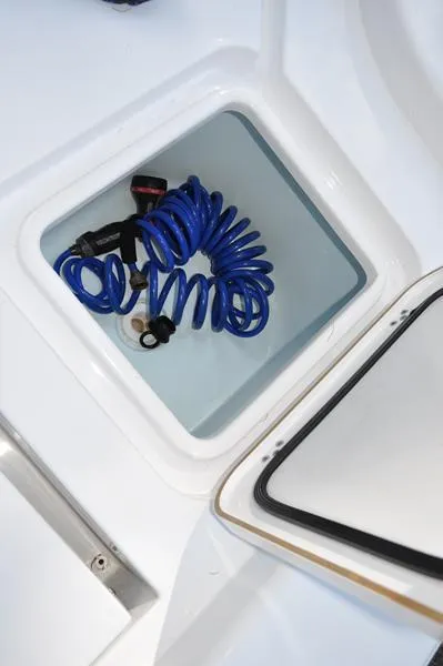 Slide: The Image of Storage compartment with blue hose on 2019 Sportsman Masters 267 Bay Boat. - 15