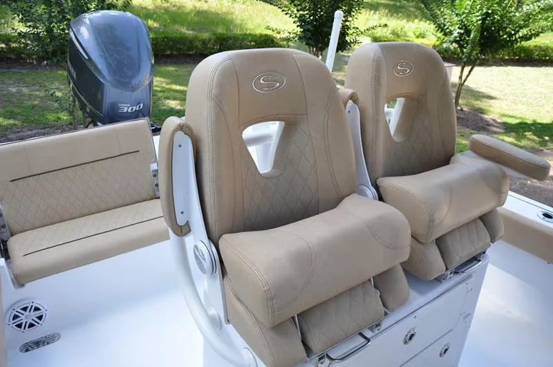 Slide: The Image of 2019 Sportsman Masters 267 Bay Boat with tan cushioned seats and Yamaha 300 engine. - 19