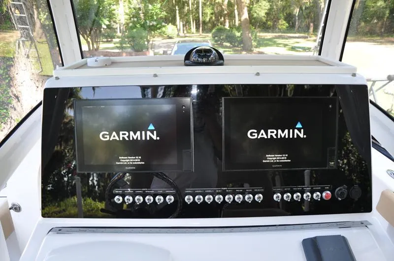 Slide: The Image of 2019 Sportsman Masters 267 Bay Boat dashboard with dual Garmin displays. - 21