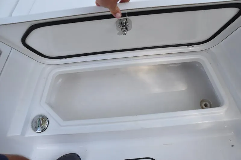Slide: The Image of 2019 Sportsman Masters 267 Bay Boat storage compartment with open lid. - 34