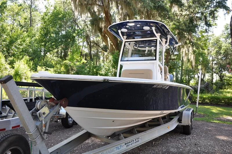 Slide: The Image of 2019 Sportsman Masters 267 Bay Boat on trailer in wooded area. - 5
