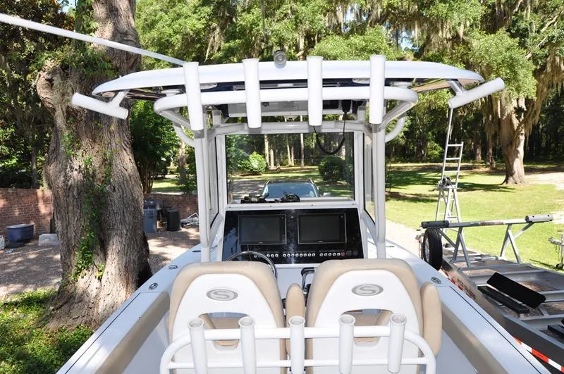 Slide: The Image of 2019 Sportsman Masters 267 Bay Boat with dual consoles and lush green background. - 7
