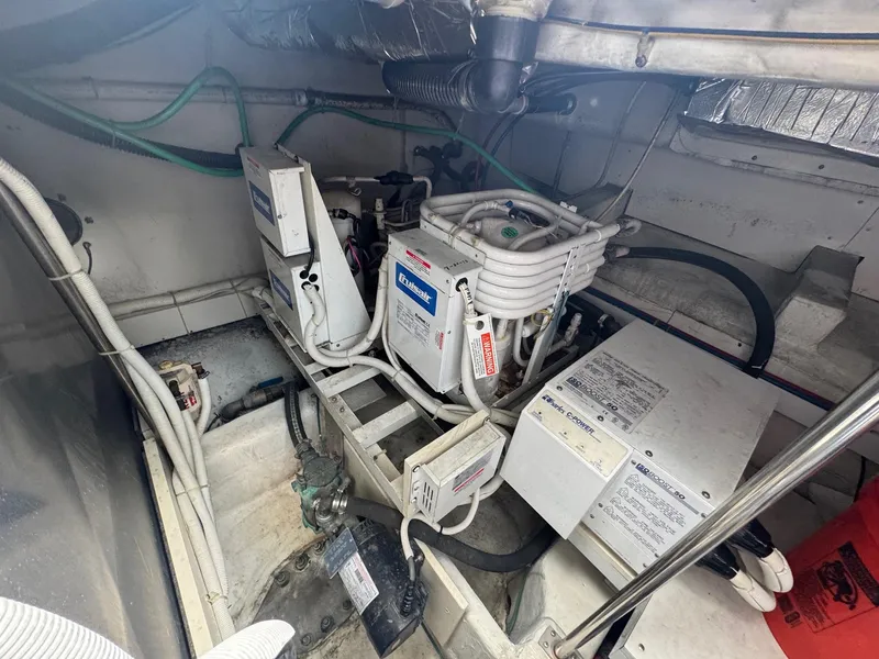Slide: The Image of Engine room of 2003 Carver 570 Voyager Pilothouse with mechanical equipment and wiring. - 11