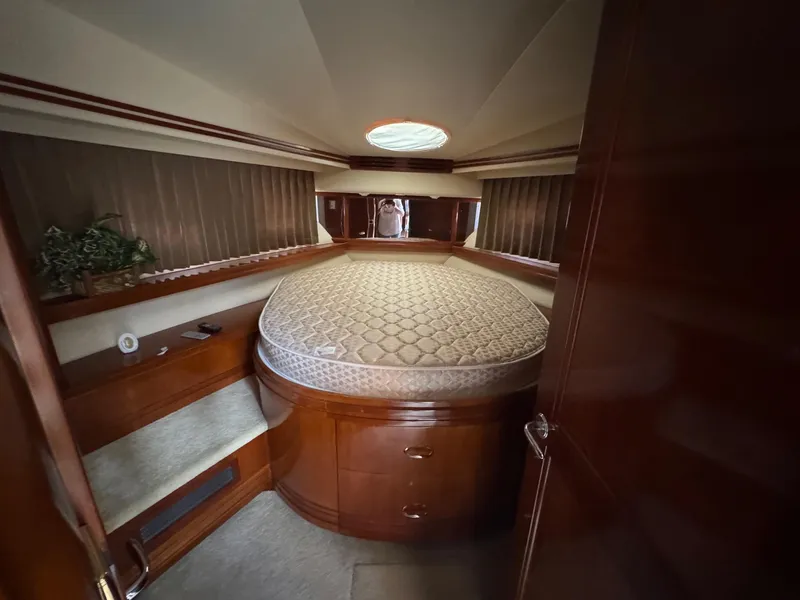 Slide: The Image of Luxurious bedroom interior of 2003 Carver 570 Voyager Pilothouse yacht with elegant wood finish. - 13