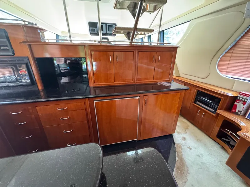 Slide: The Image of Luxurious interior of 2003 Carver 570 Voyager Pilothouse with wood cabinetry and modern appliances. - 5