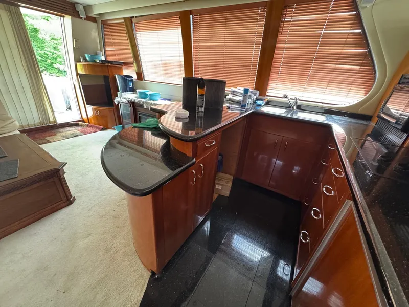 Slide: The Image of Luxurious kitchen interior of 2003 Carver 570 Voyager Pilothouse with wood cabinetry and granite countertops. - 6