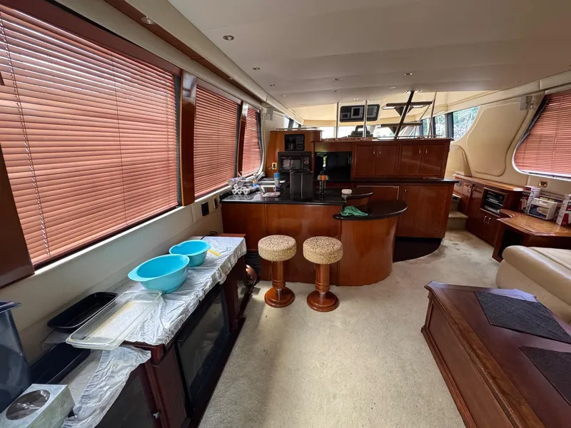 Slide: The Image of Interior of 2003 Carver 570 Voyager Pilothouse with kitchen and seating area. - 7