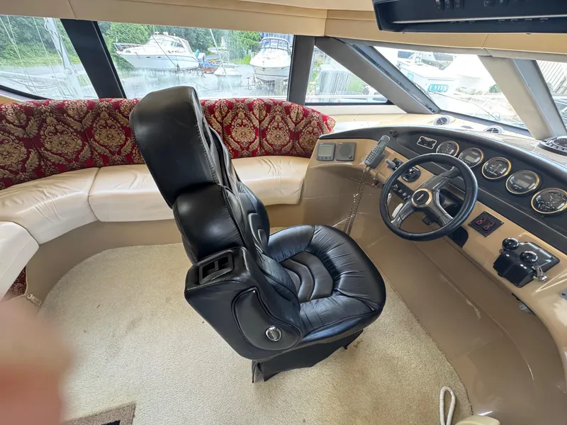 Slide: The Image of 2003 Carver 570 Voyager Pilothouse interior with leather captain's chair and control panel. - 9