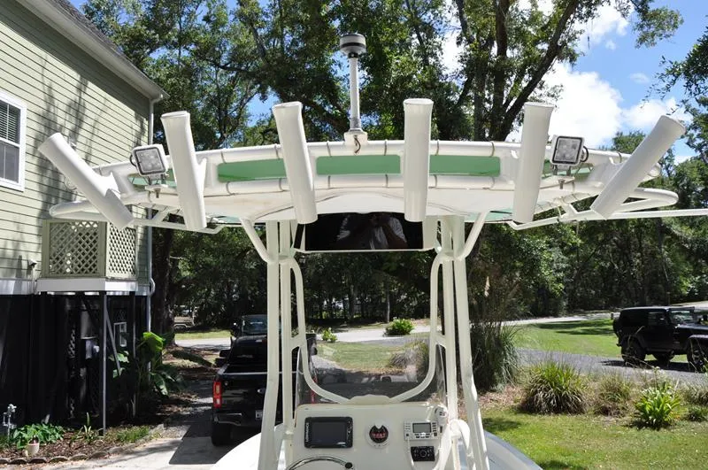 Slide: The Image of 2017 Skeeter SX 210 boat with T-top and rod holders, parked outdoors. - 10