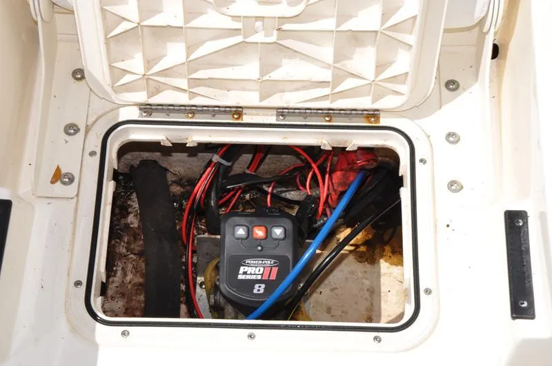 Slide: The Image of 2017 Skeeter SX 210 boat battery compartment with wiring and Pro Series 8 charger. - 15