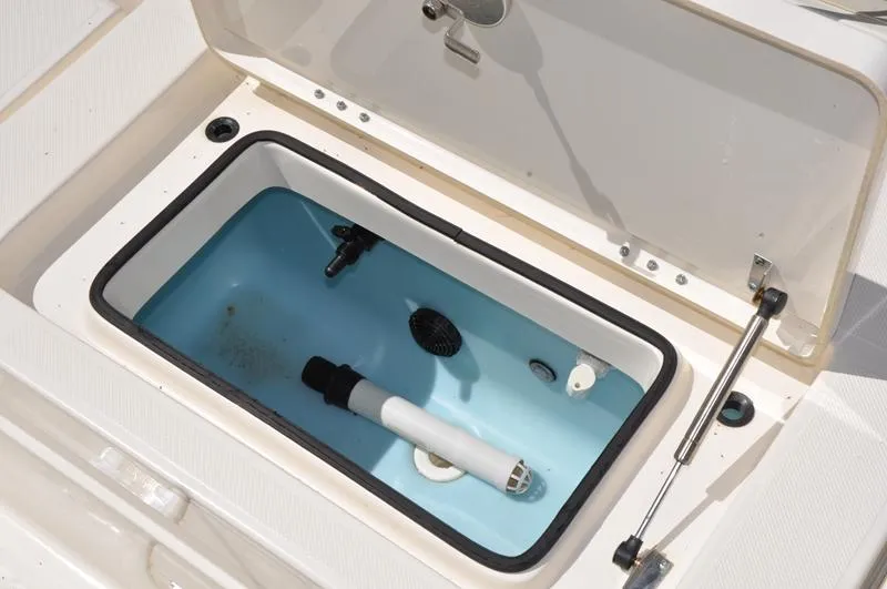 Slide: The Image of Open livewell compartment on 2017 Skeeter SX 210 boat, showing interior features. - 16