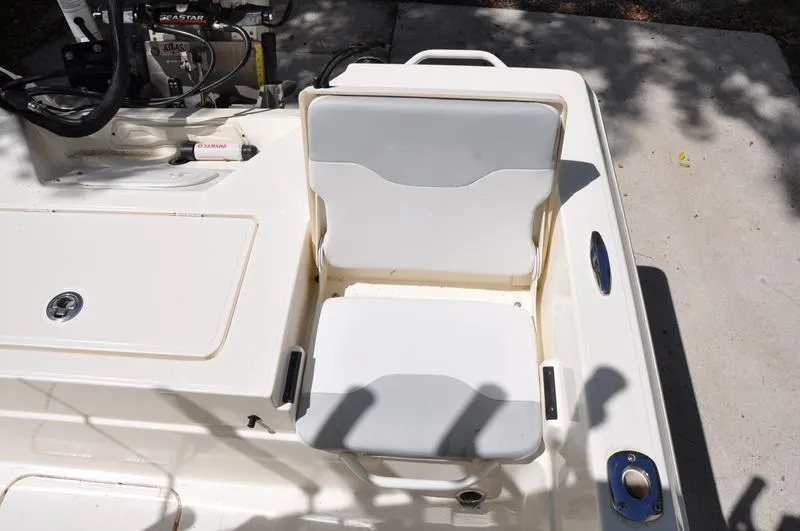 Slide: The Image of 2017 Skeeter SX 210 boat seat and console, featuring white cushioned seating. - 17