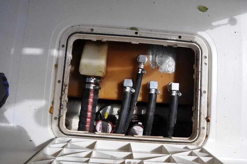 Slide: The Image of 2017 Skeeter SX 210 boat compartment with hoses and fittings. - 18