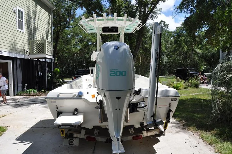 Slide: The Image of 2017 Skeeter SX 210 boat with Yamaha 200 engine, parked in a driveway. - 2