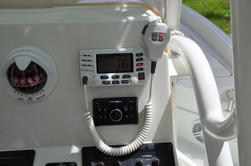 Slide: The Image of Control panel of a 2017 Skeeter SX 210 boat with radio and compass. - 23