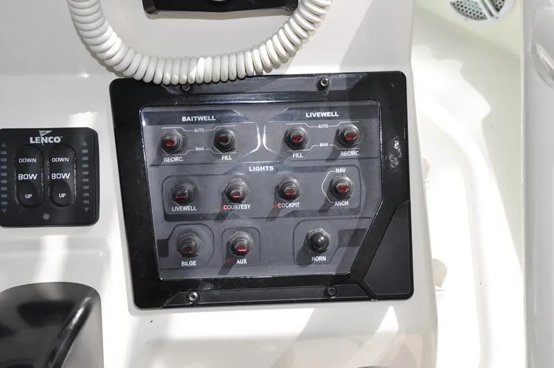 Slide: The Image of Control panel of a 2017 Skeeter SX 210 boat with various switches and buttons. - 24