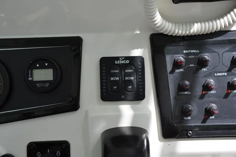 Slide: The Image of Control panel of a 2017 Skeeter SX 210 boat with Lenco trim tab switches. - 25