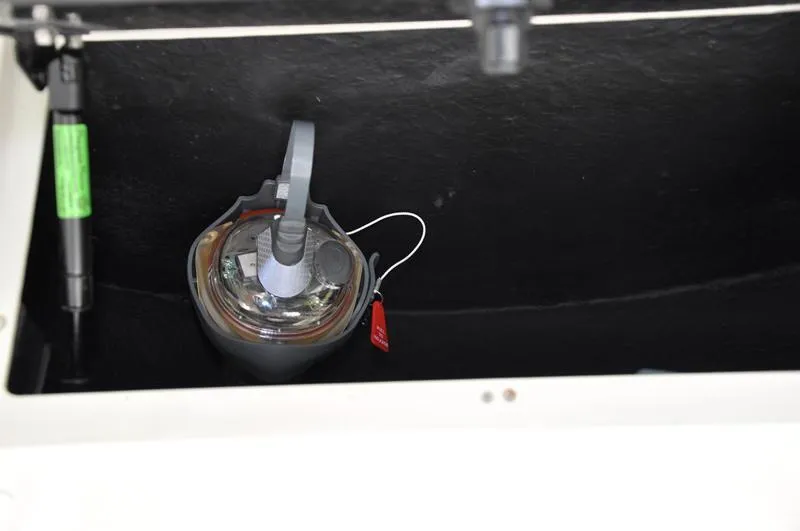 Slide: The Image of Storage compartment of 2017 Skeeter SX 210 boat with a secured item inside. - 26