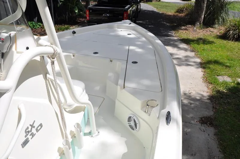 Slide: The Image of 2017 Skeeter SX 210 boat on a driveway, showcasing spacious deck and storage compartments. - 28