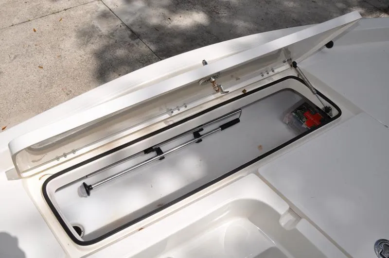 Slide: The Image of 2017 Skeeter SX 210 boat storage compartment with hydraulic lift and first aid kit. - 29