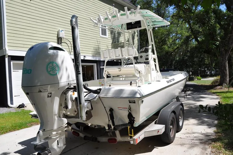 Slide: The Image of 2017 Skeeter SX 210 boat on trailer, parked in driveway, with Yamaha outboard motor. - 3