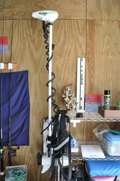 Slide: The Image of 2017 Skeeter SX 210 boat equipment in a garage with fishing gear and tools. - 37