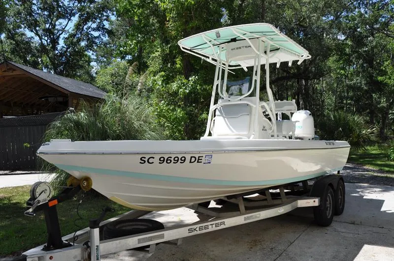 Slide: The Image of 2017 Skeeter SX 210 boat on trailer in wooded area. - 6