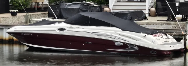 The Image of 2006 Sea Ray 270 Sundeck boat docked with cover on, side view. - 0