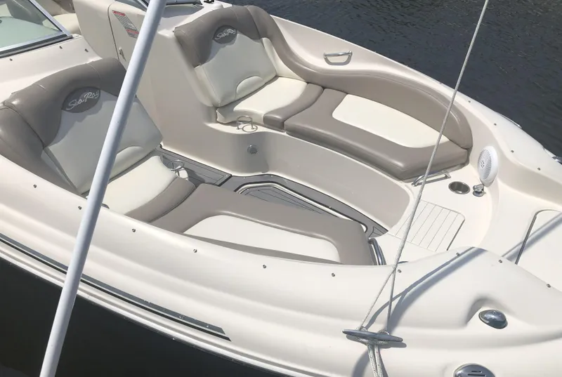 Slide: The Image of 2006 Sea Ray 270 Sundeck boat interior with cushioned seating and cup holders. - 14