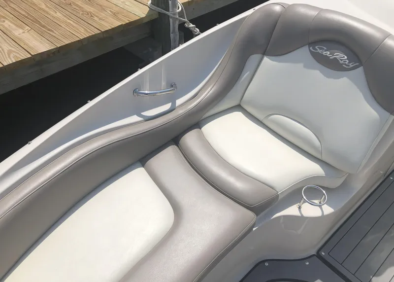 Slide: The Image of 2006 Sea Ray 270 Sundeck boat interior with gray and white seating. - 15