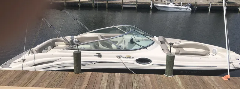 Slide: The Image of 2006 Sea Ray 270 Sundeck boat docked at a marina. - 17