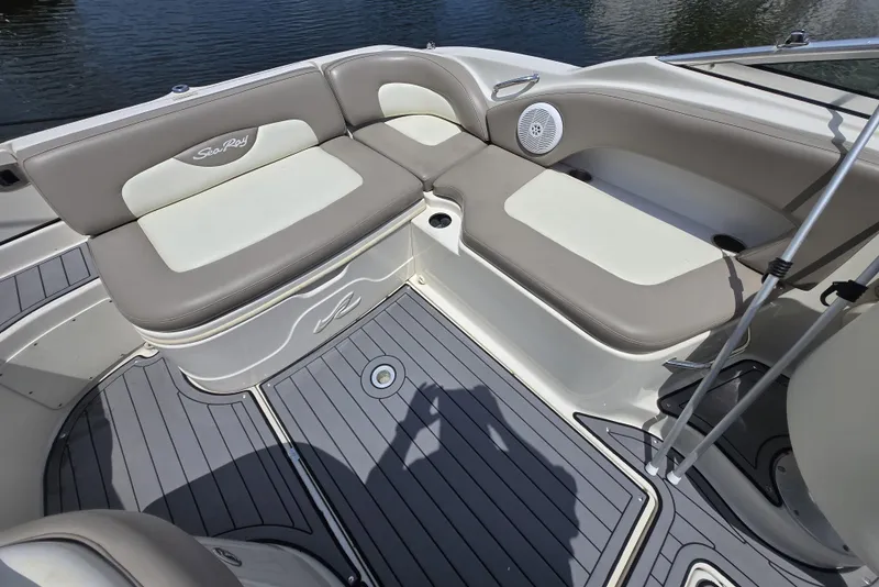 Slide: The Image of 2006 Sea Ray 270 Sundeck interior with cushioned seating and speaker, on water. - 18