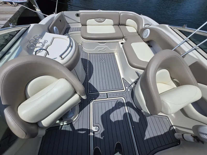 Slide: The Image of Interior of a 2006 Sea Ray 270 Sundeck boat with cushioned seating and sleek design. - 2