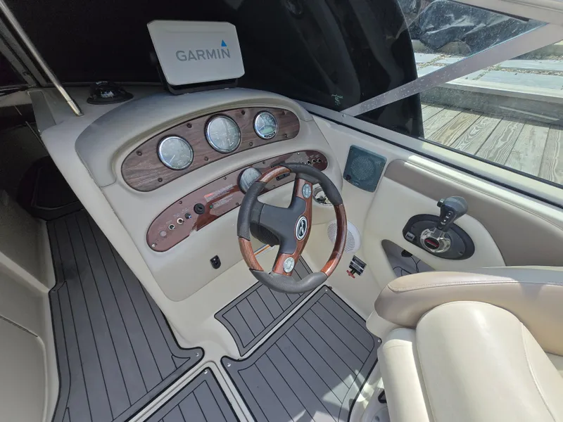 Slide: The Image of 2006 Sea Ray 270 Sundeck helm with Garmin navigation, wood accents, and modern controls. - 20