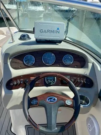 Slide: The Image of 2006 Sea Ray 270 Sundeck helm with Garmin navigation system and classic wood accents. - 6