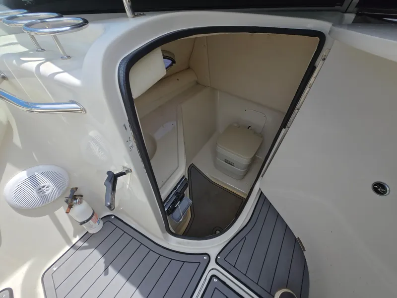 Slide: The Image of Interior of 2006 Sea Ray 270 Sundeck boat showing compact bathroom area. - 8