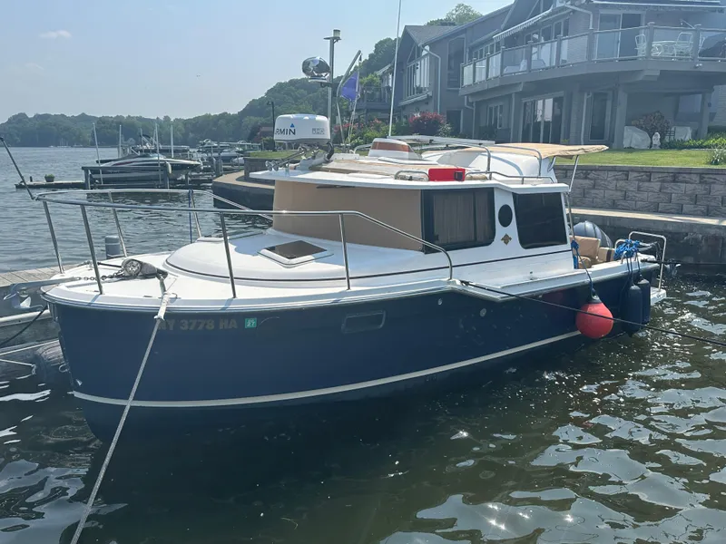 The Image of 2019 Ranger Tugs R-23 boat docked by waterfront homes. - 0