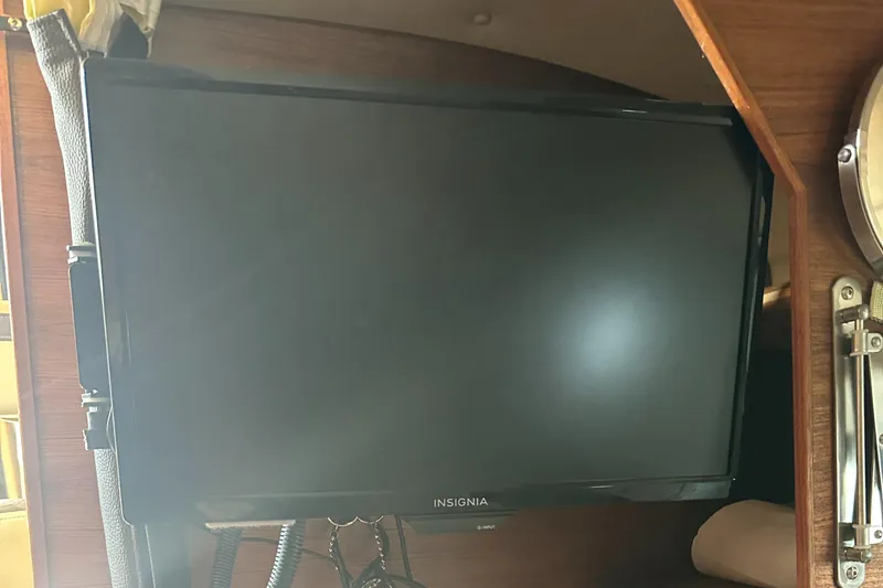 Slide: The Image of Insignia TV inside 2019 Ranger Tugs R-23 boat cabin, mounted on wooden panel. - 12