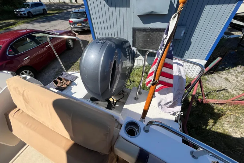 Slide: The Image of 2019 Ranger Tugs R-23 boat with Yamaha outboard motor and American flag. - 15