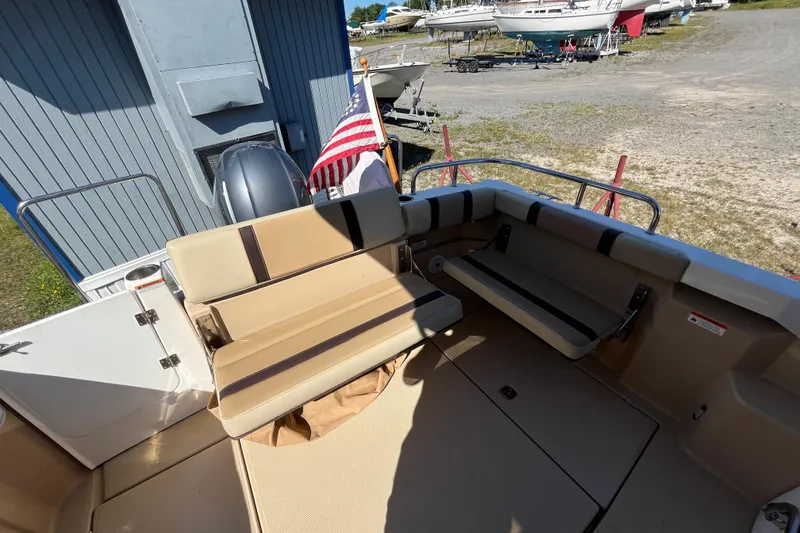 Slide: The Image of 2019 Ranger Tugs R-23 boat interior with seating and American flag. - 17