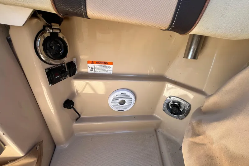 Slide: The Image of 2019 Ranger Tugs R-23 boat interior with speaker, warning label, and control panel. - 19