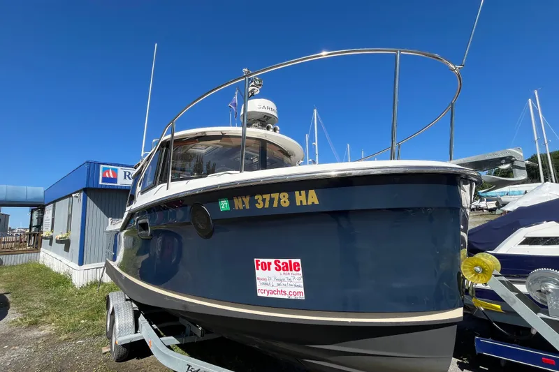 Slide: The Image of 2019 Ranger Tugs R-23 boat for sale, displayed on a trailer at a marina. - 22