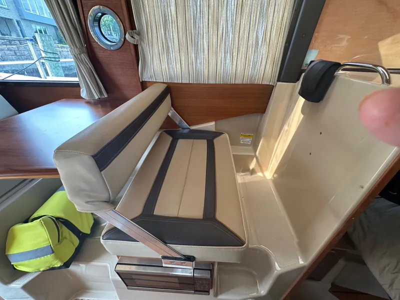 Slide: The Image of Interior of a 2019 Ranger Tugs R-23 boat with seating and table. - 8