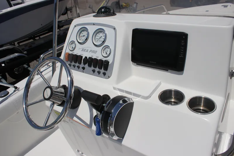 Slide: The Image of 2008 Sea Pro 186 Center Console dashboard with steering wheel, gauges, and cup holders. - 10