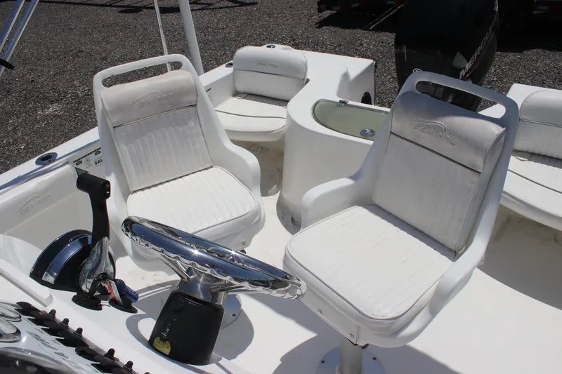 Slide: The Image of 2008 Sea Pro 186 Center Console boat interior with white seating and steering wheel. - 9